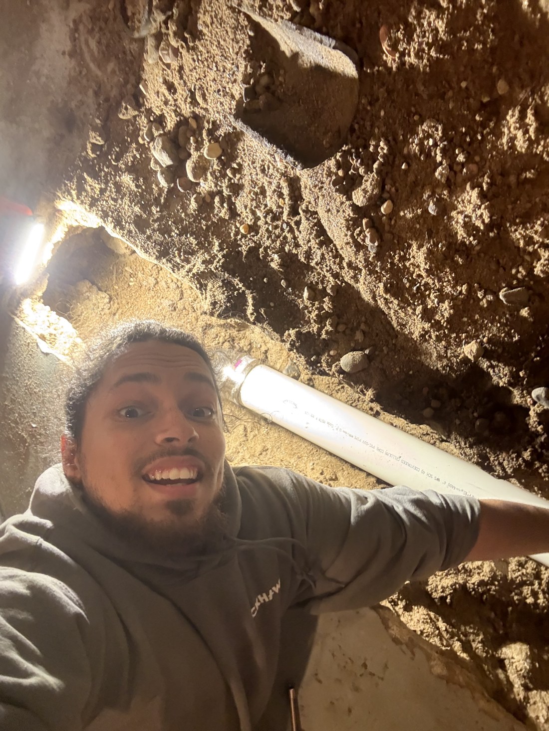 Elijah, drain operations lead at Stratum, fitting a new drain line